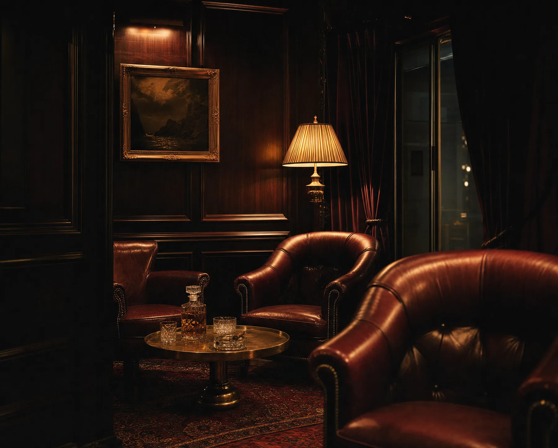 A private lounge with oxblood leather club chairs, walnut panelling and a brass table set with a decanter.
